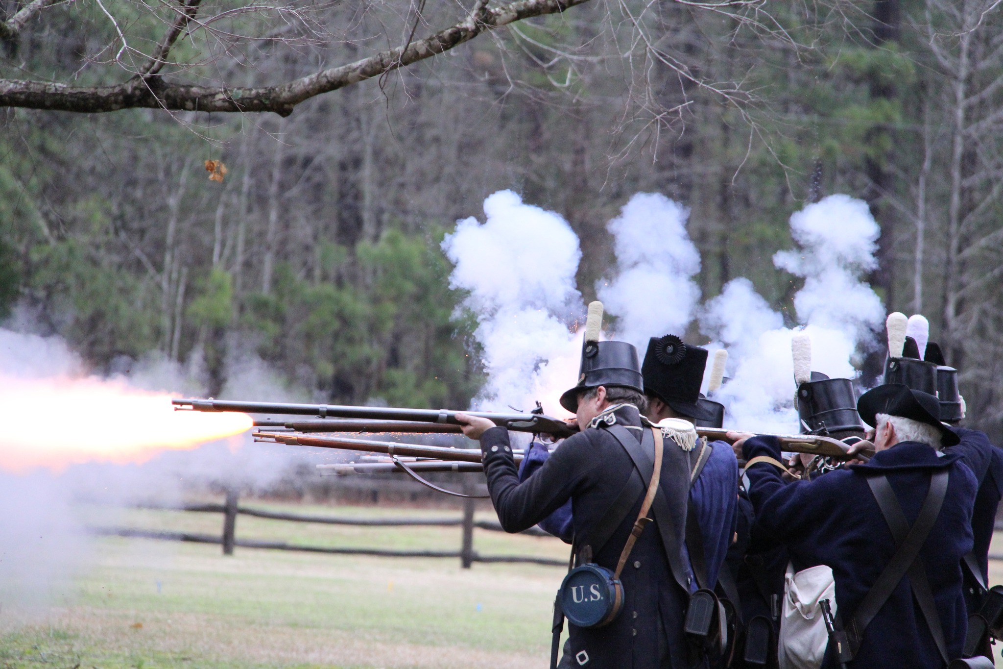 Reenactors firing muskets