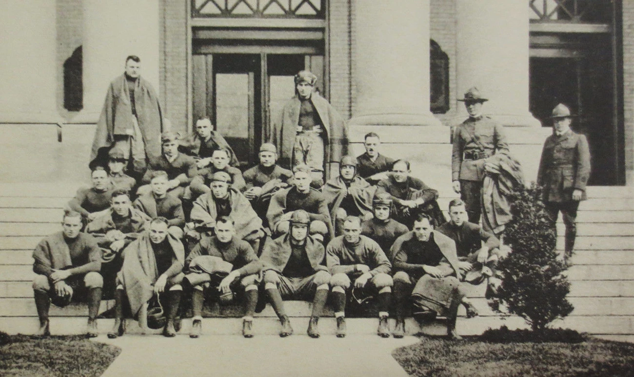 83rd Div. Football Team Football players sitting on the steps to a building