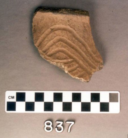 A small piece of pottery atop a black and white scaler