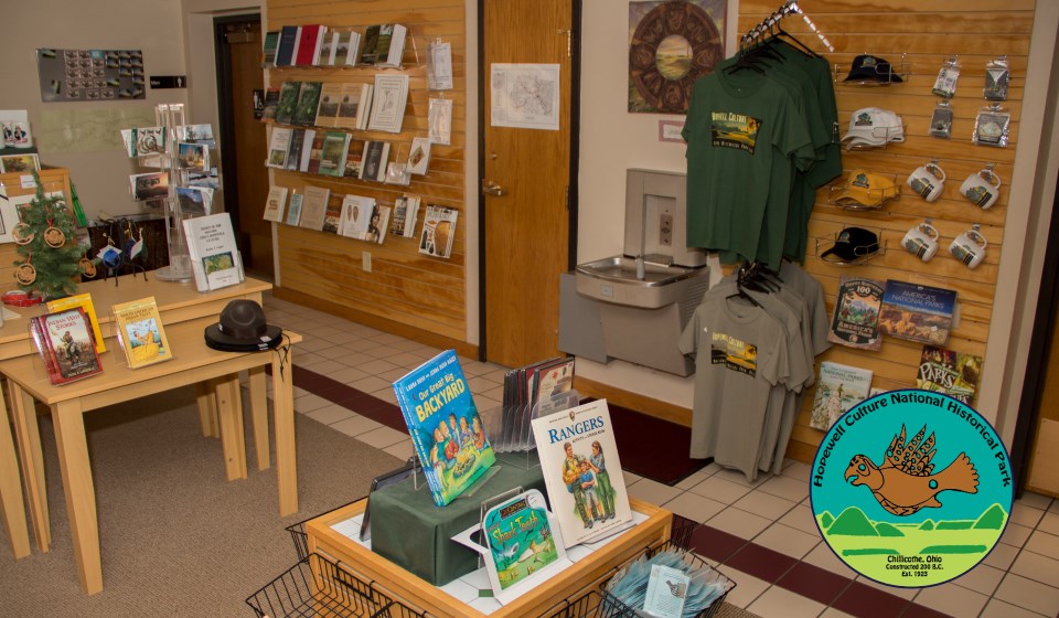 Books and other gifts neatly displayed on a wall and podiums Books and other gifts neatly displayed on a wall and podiums