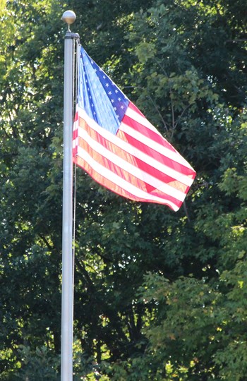 Flag at Mound City Group An American flag waves on a flagpole in front of trees