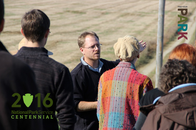 Dr. Jarrod Burks speaking to a group of people at Hopeton Earthworks