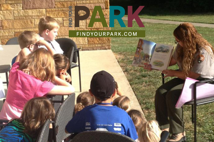 Ranger reading to kids during Arts Afire program