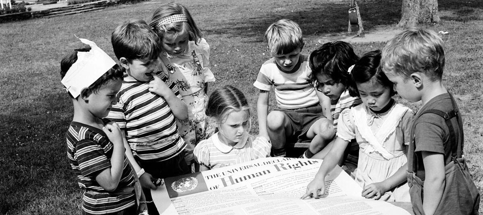Children looking at a copy of the UDHR