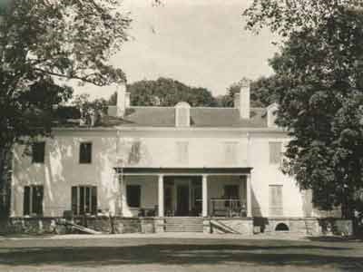 A large house with front porch under construction.