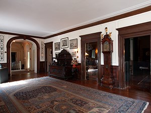 A large room with many framed prints covering the walls.