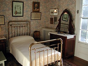 A small room with brass bed.