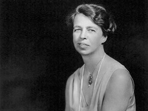 A head and shoulder portrait of a seated woman (Eleanor Roosevelt) wearing a gown and pearls.