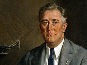 A painted portrait of a man (FDR) wearing a suit. A model of a ship is in the background.