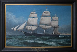 A painting of a clipper ship at sea in a black frame.