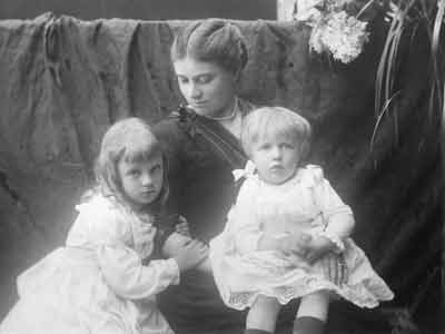 A mother with two children at her lap.