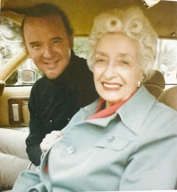 Toi and Raleigh DeGeer Amyx seated together in a car smiling for the camera.