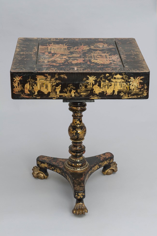 A game table decorated with Chinese scenes.