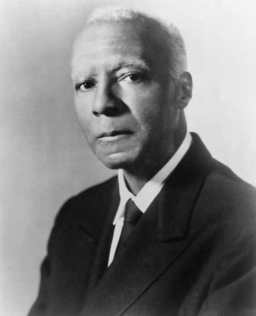 A. Philip Randolph dressed in a suit and tie.