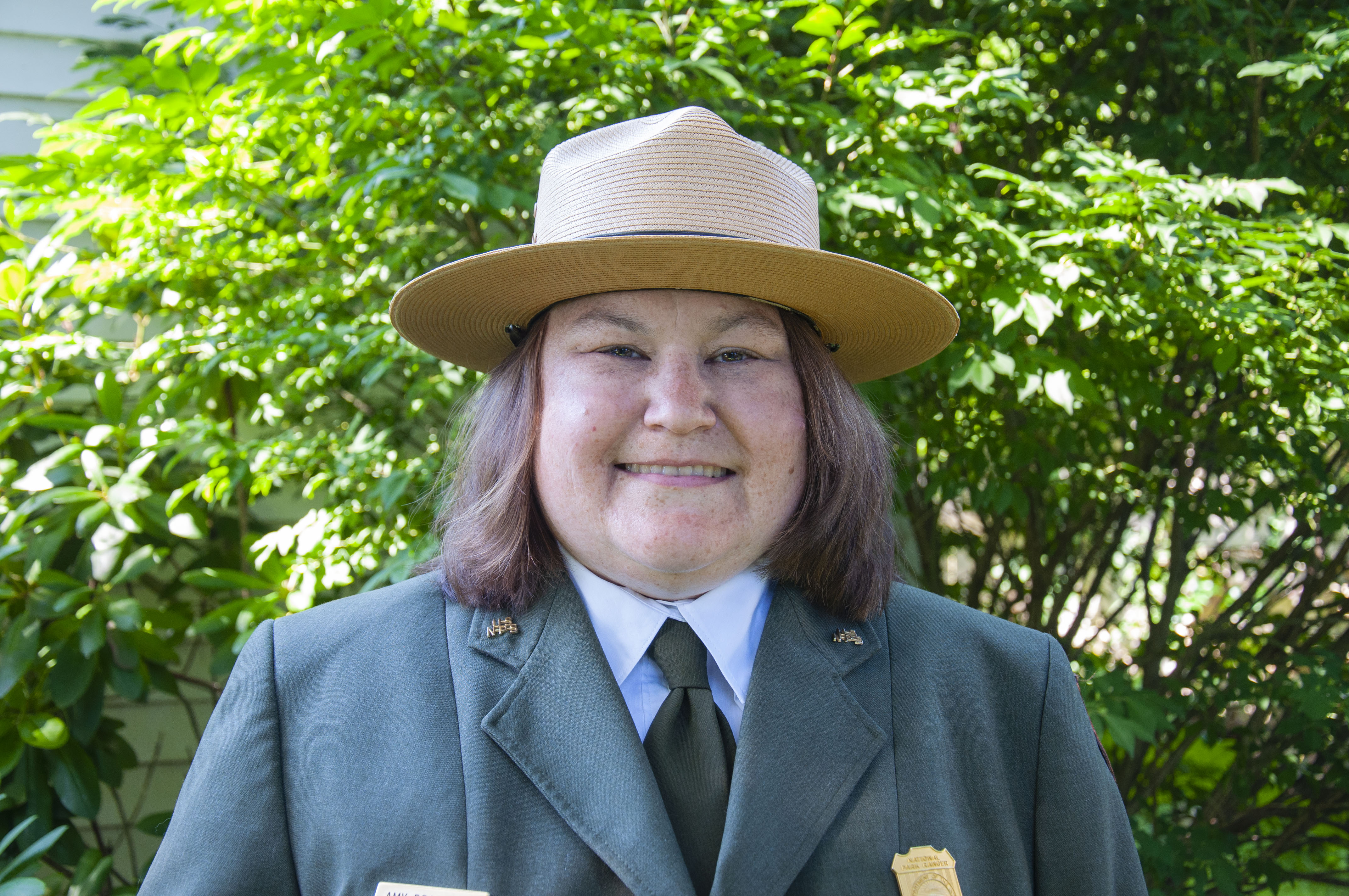 A woman in a National Park Service uniform smiles