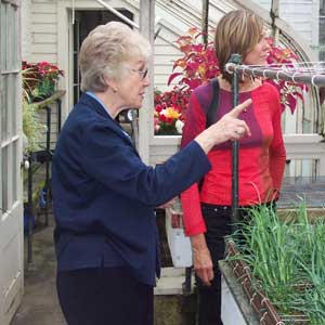 Volunteer conducting tour of greenhouse at FDR site