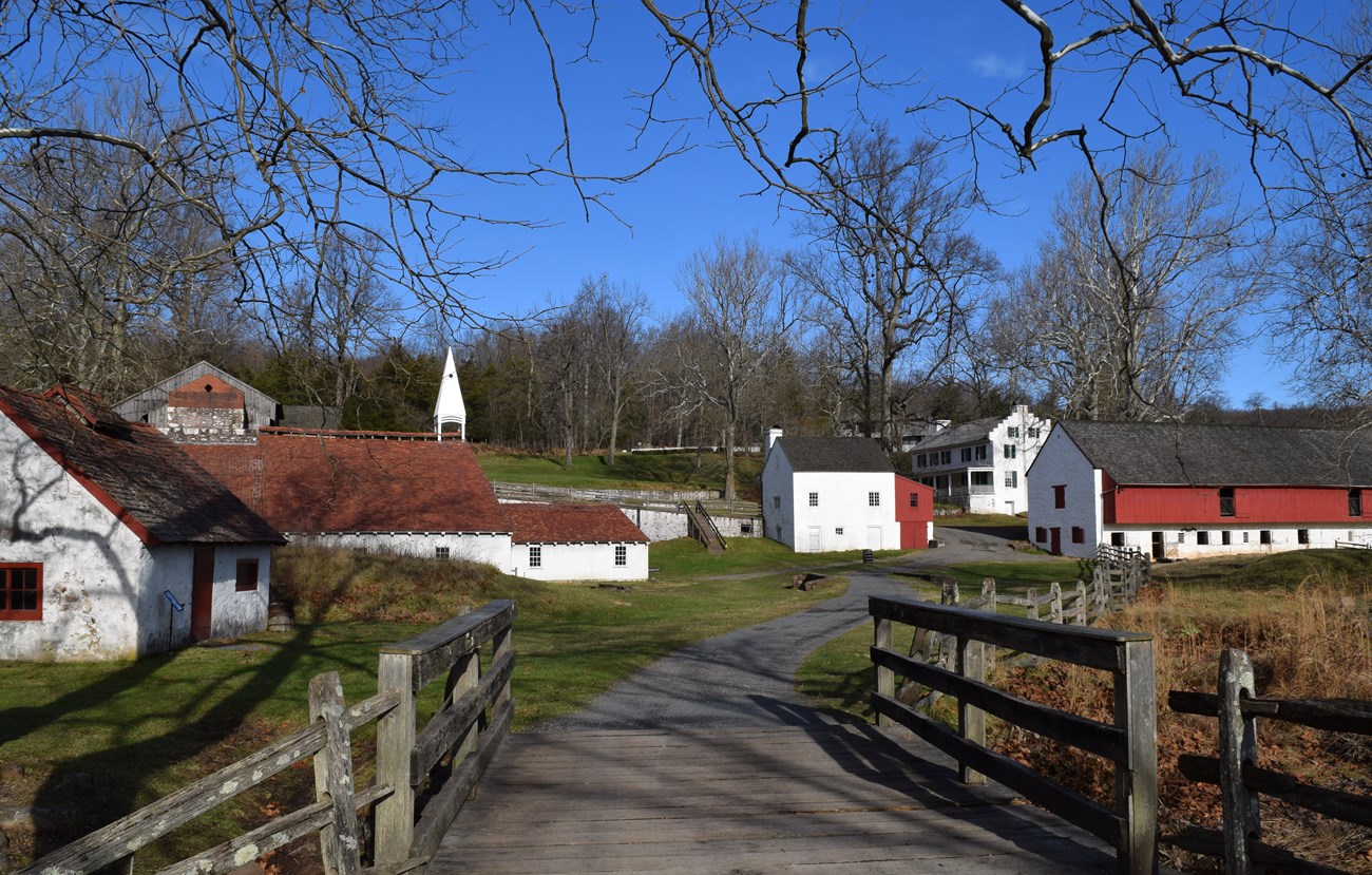 View of Cast House, Blacksmith Shop, Barn, Office/Store, Ironmaster's Mansion from French Creek Bridge.
