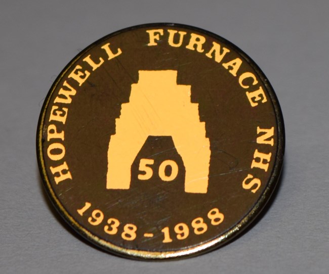 Commemorative pin that reads: "Hopewell Furnace NHS", "1938 to 1988". An illustration of the furnace stack has the number 50 written inside of it.