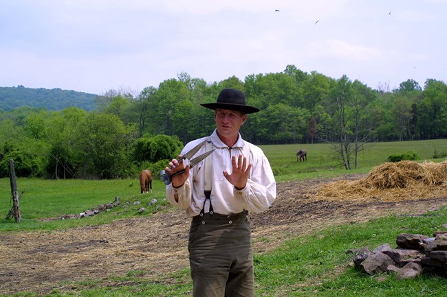Man holds a pair of shears used to shear sheep.