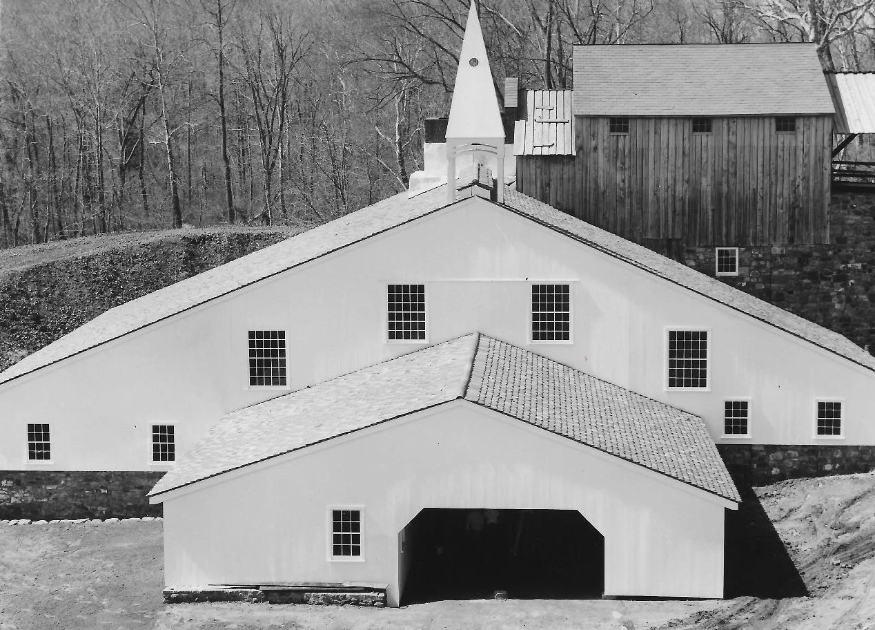 reconstructed Cast House as completed in 1965 Black and white photograph of large building with triangular roof.