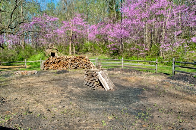 Wood stacked in a charcoal hearth in preparation for a burn.