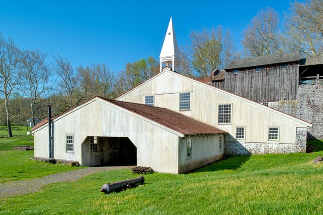 White structure with red tile roof housed the stone furnace stack.