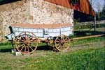 Conestoga wagon with the typical blue painted body and red wheels. Conestoga wagon with the typical blue painted body and red wheels.