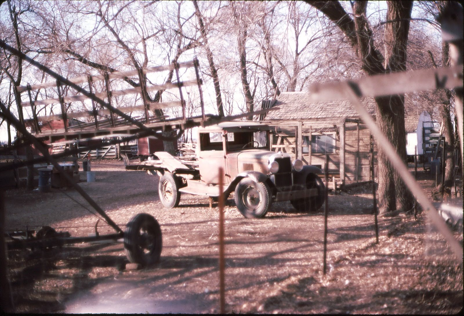 MicrosoftTeams-image (5) A truck parked on a homestead near farm equipment