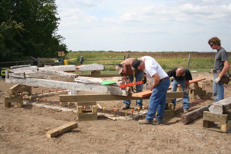 The logs of the cabin are beginning to be reassembled.