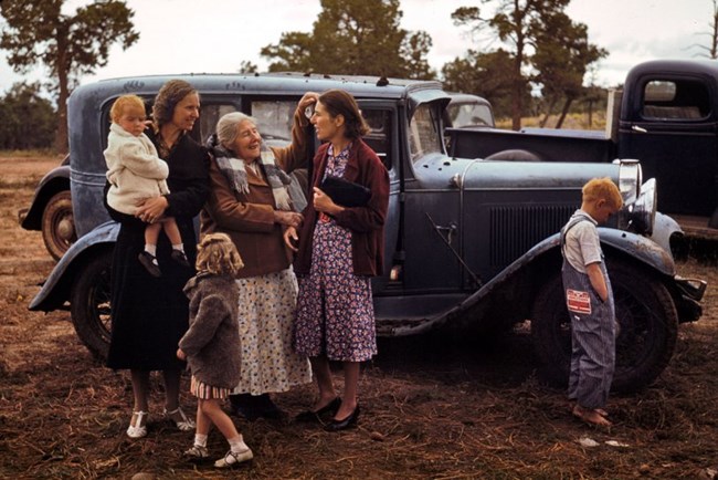 Group of people standing next to a car