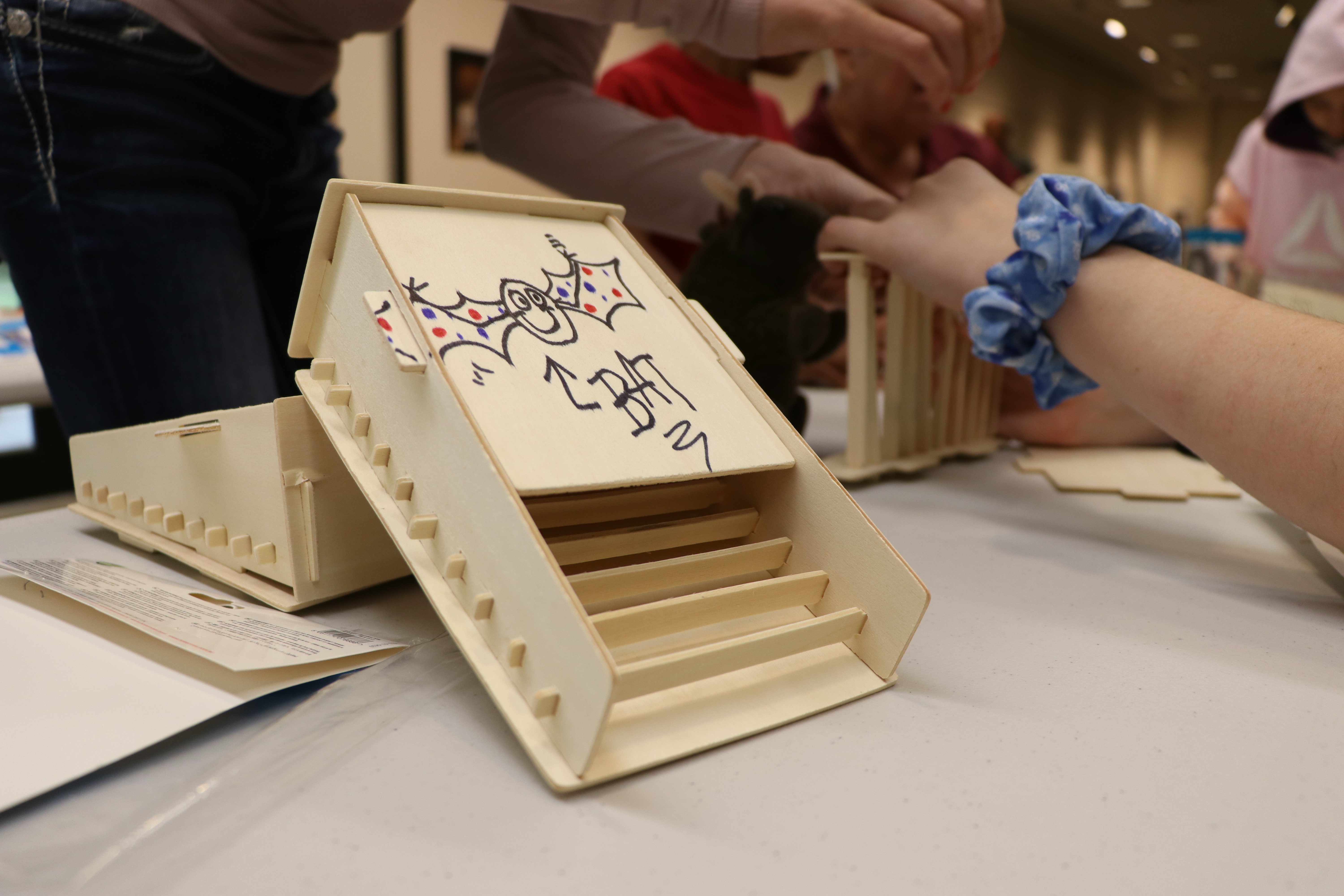 An example of a wooden bat house being built by kids.