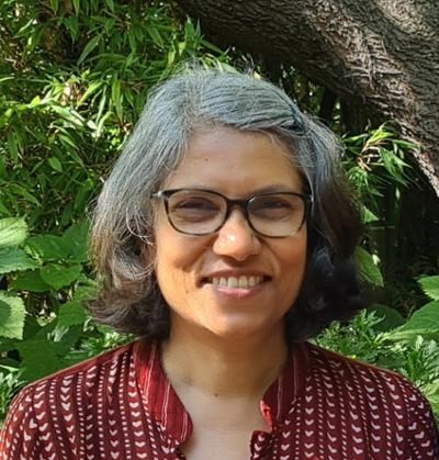 A woman with glasses smiling