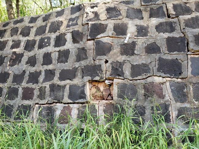 an old dark brick and mortar wall
