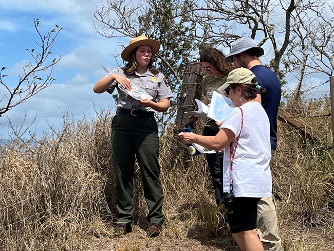 A park ranger giving a tour to three people