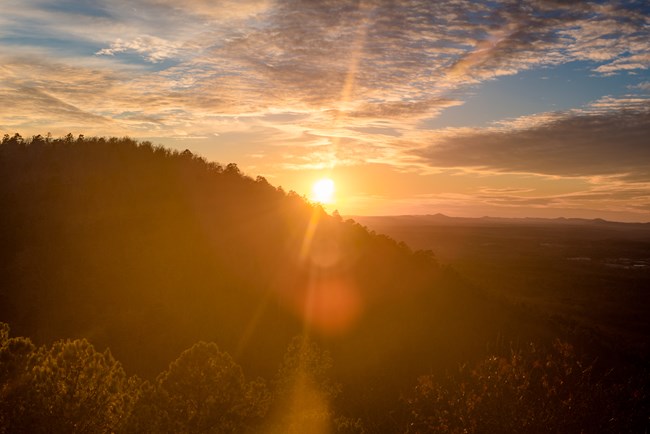 Sun setting behind mountain