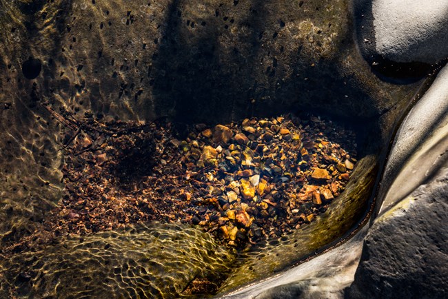 Tiny rocks at the bottom of a creek