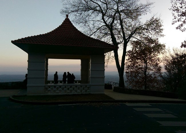 People in a pagoda during sunset