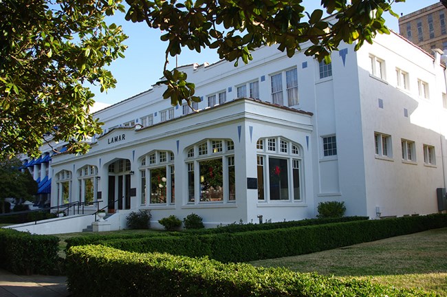 Lamar Bathhouse viewed from the southwest along the Magnolia Promenade sidewalk.