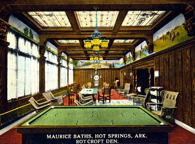 Wood paneled room with bright sky lights, billiard table, chairs, and handpainted frieze