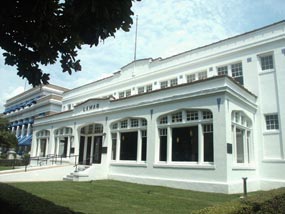 color photo from the south end front of the Lamar. It is a white stucco building with large multipaned windows and blue tile insets between windows on the second floor. color photo from the south end front of the Lamar. It is a white stucco building with large multipaned windows and blue tile insets between windows on the second floor.