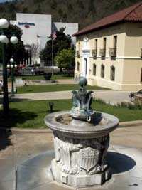 color photo of Noble Fountain (1892) which has a light gray marble base decorated with a federal shield and a bronze upper that consists of three bald eagles with wings spread and a ball rising between them color photo of Noble Fountain (1892) which has a light gray marble base decorated with a federal shield and a bronze upper that consists of three bald eagles with wings spread and a ball rising between them