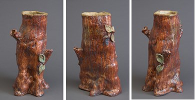 Three views of a ceramic sculpture of a the lower part of a tree trunk with a medium reddish-brown glaze on the outside and a light brown, almost cream, glaze in the inside. There are tree branch stubs on two sides of the trunk and some green leaves grouped on opposite sides.