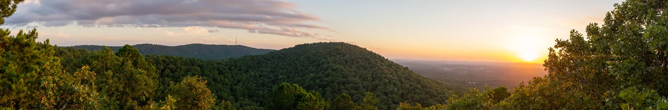 Balanced Rock Overlook A view of rolling hills and a setting sun.