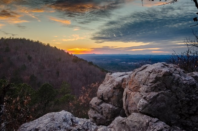 Vista of rolling mountains and the sunset from Balanced Rock in the Park.