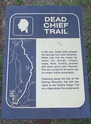 Photo of Dead Chief trailhead sign made of dark brown metal with gold lettering and map of the trail Photo of Dead Chief trailhead sign made of dark brown metal with gold lettering and map of the trail