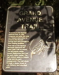 Photo of Grand Avenue trailhead sign with shadow over upper half of picture. Sign is dark brown metal with gold lettering and map of trails on Hot Springs and North Mountains Photo of Grand Avenue trailhead sign with shadow over upper half of picture. Sign is dark brown metal with gold lettering and map of trails on Hot Springs and North Mountains