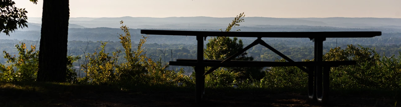 West Mountain Picnic A picnic table in the shade on top of West Mountain with a view of rolling blue hills in the distance