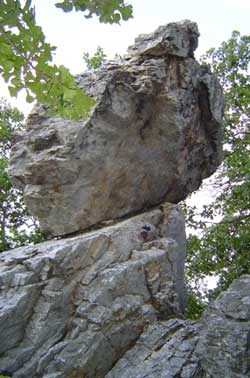 a gray novaculite rock formation with one large oval piece looks like it is on end balanced on the lower larger formation a gray novaculite rock formation with one large oval piece looks like it is on end balanced on the lower larger formation