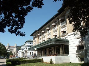 Historic Fordyce Bathhouse from south front end. Three story building with tan brick on upper two stories, copper marquee porch cover. Historic Fordyce Bathhouse from south front end. Three story building with tan brick on upper two stories, copper marquee porch cover.