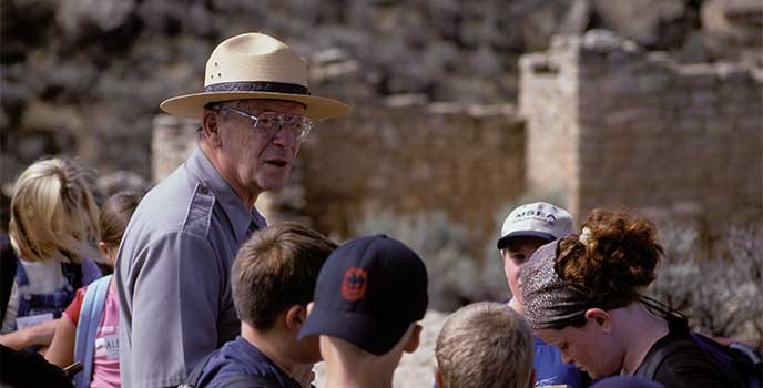 A park ranger with a group of students. A park ranger with a group of students.